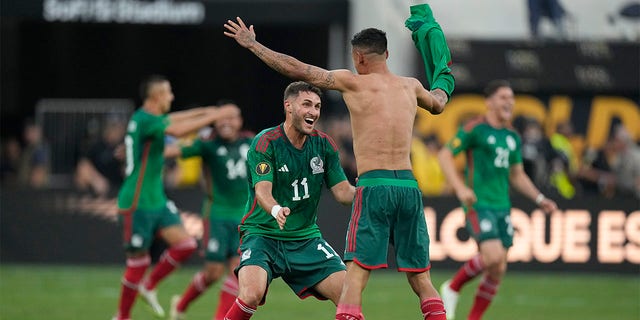 Santiago Giménez celebrates with teammate