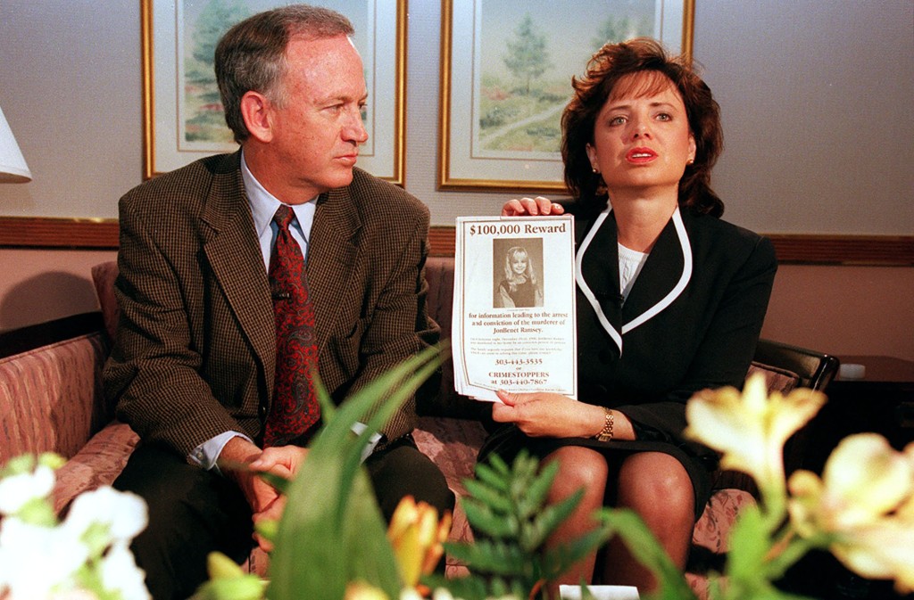 John and Patsy Ramsey hold a poster offering a reward for information on the murder of their six-year-old daughter.