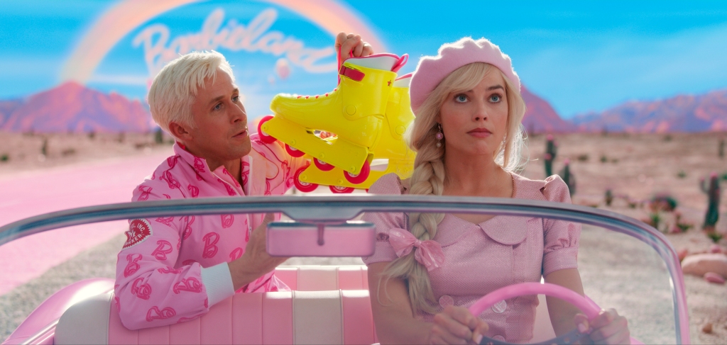 Ken (Ryan Gosling) and Barbie (Margot Robbie) in a pink convertible in a still from the "Barbie" movie.