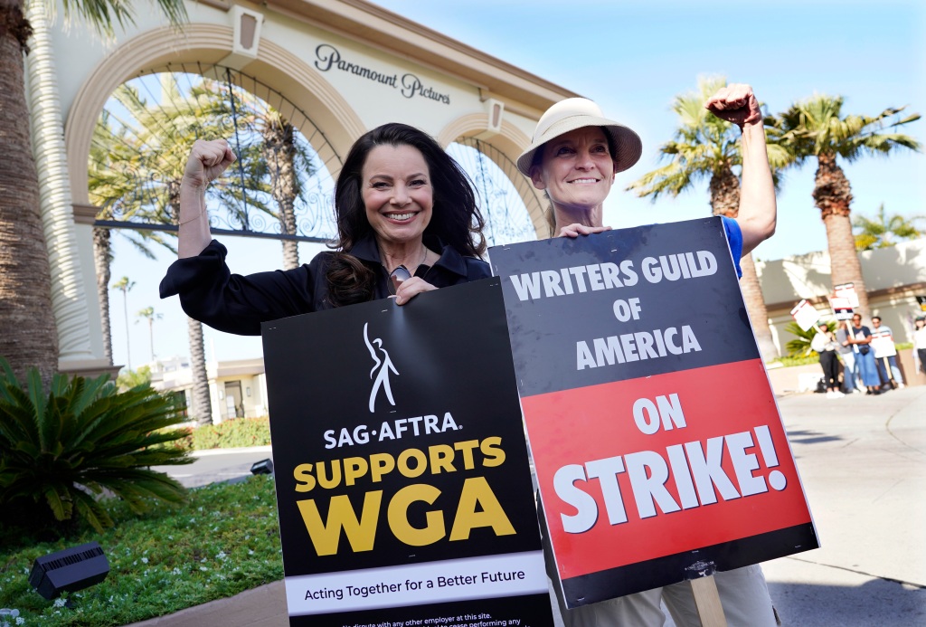 Fran Drescher, left, president of SAG-AFTRA, and Meredith Stiehm, president of Writers Guild of America West, pose together during a rally by striking writers outside Paramount Pictures studio, Monday, May 8, 2023, in Los Angeles. 