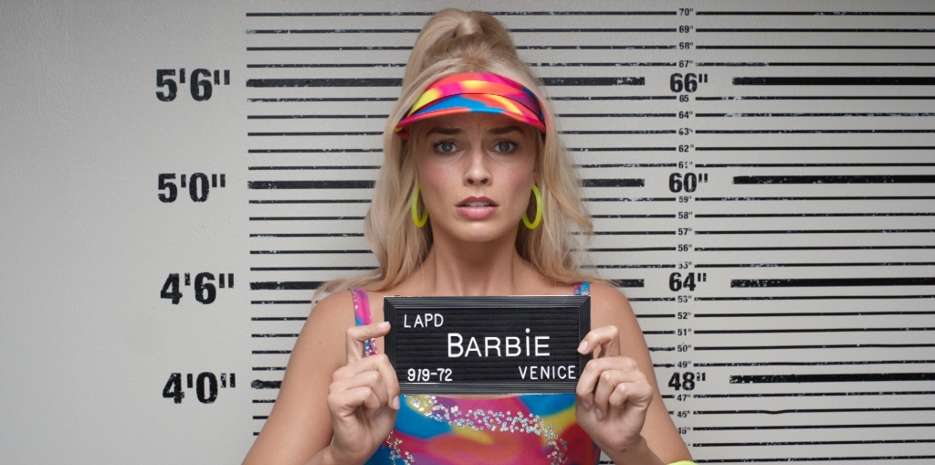 A still from Barbie showing her apparent arrest