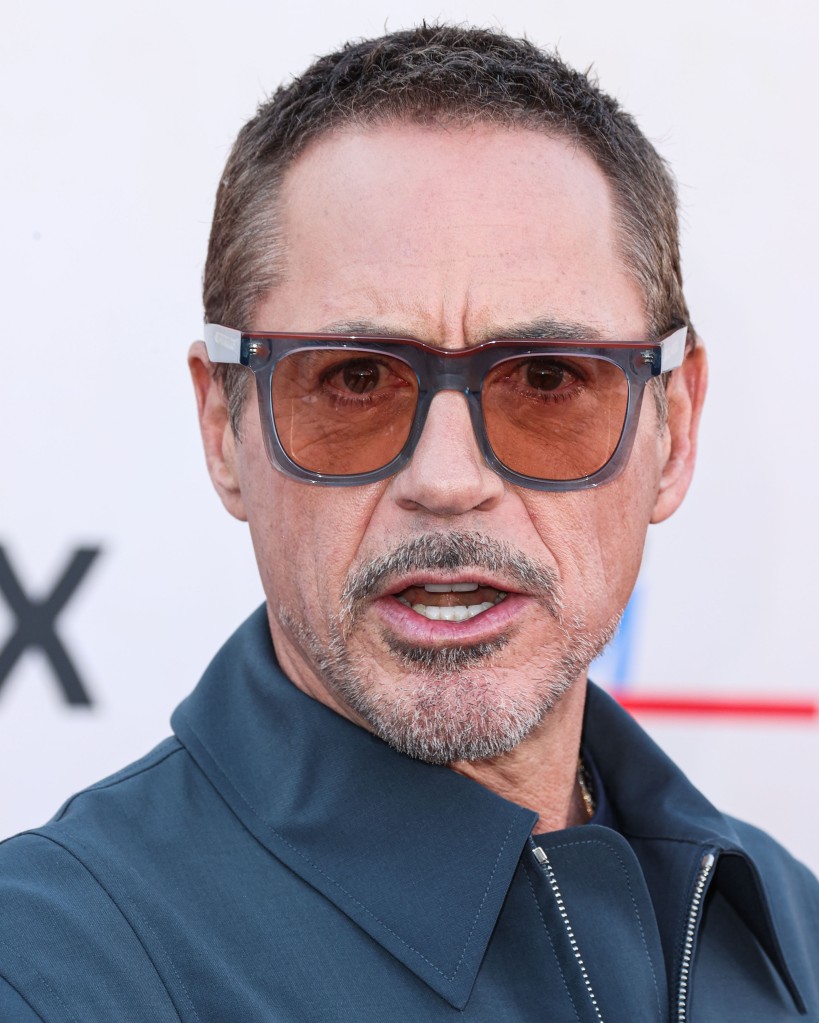 Robert Downey Jr. in tinted glasses looking serious. 