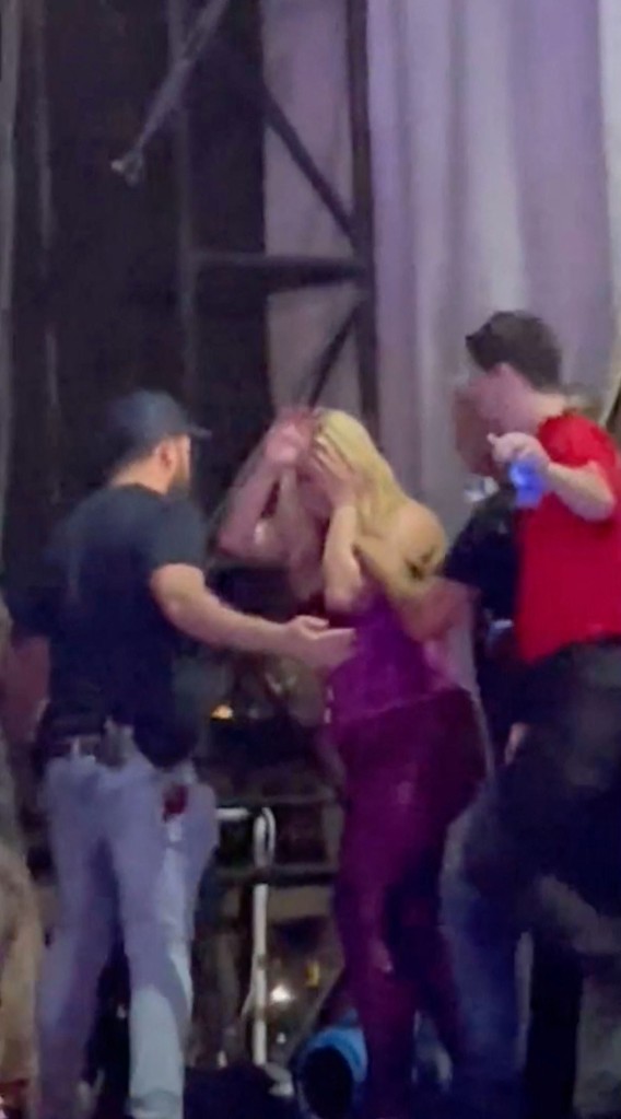 Bebe Rexha holds her face as she is taken backstage after being hit by a phone thrown from the audience during a show. The singer fell to her knees and had to be helped off stage after being struck while performing at The Rooftop at Pier 17 in New York City.