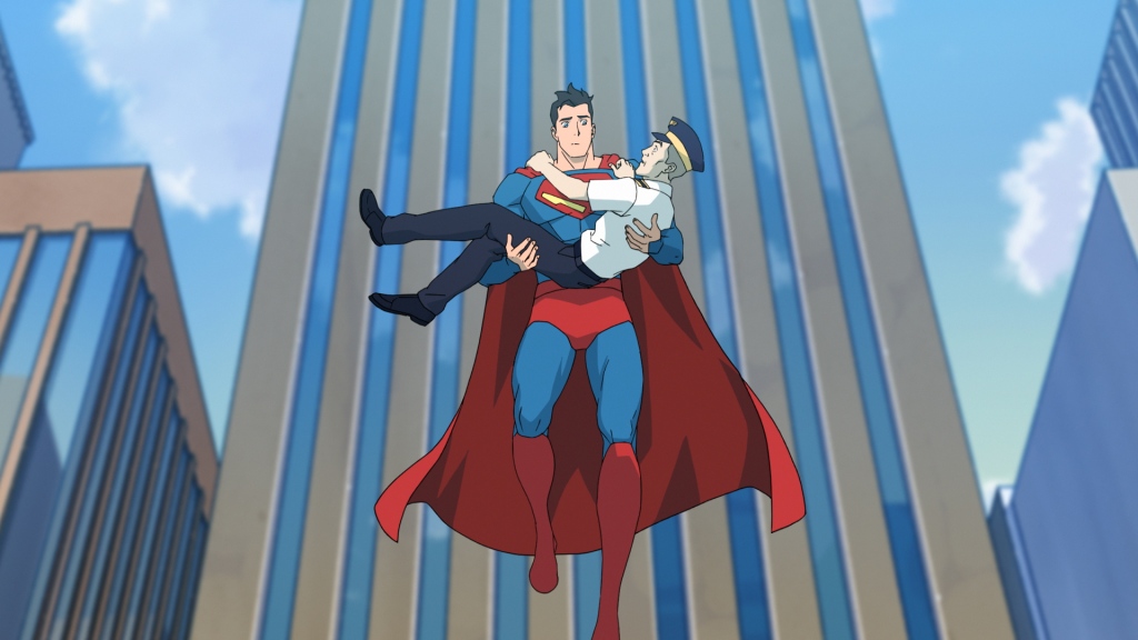 Cartoon Superman floats in the air holding a cop in his arms by a tall building. 