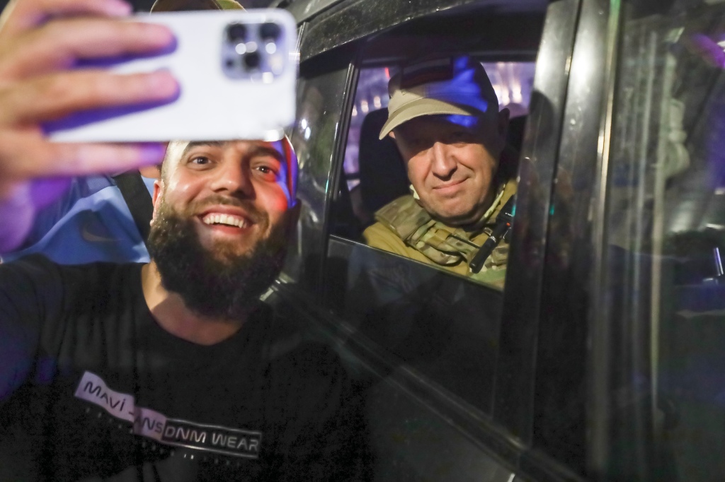 Yevgeny Prigozhin poses for a selfie with an admirer before leaving Rostov-on-Don