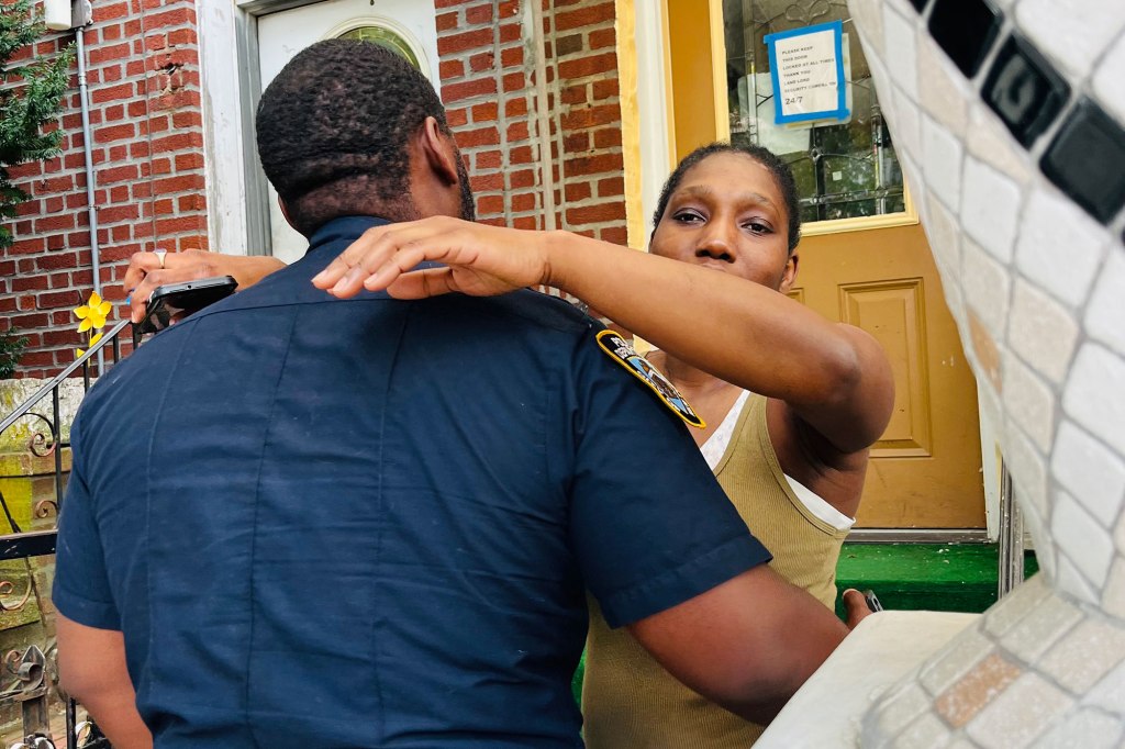 NYPD officer gives Javen Fraser's mom a hug on Friday