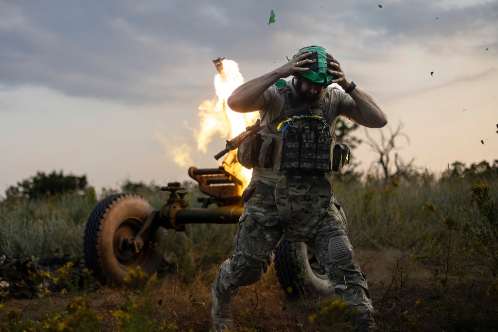 A Ukrainian serviceman of the 3rd Assault Brigade fires a 122mm mortar towards Russian forces