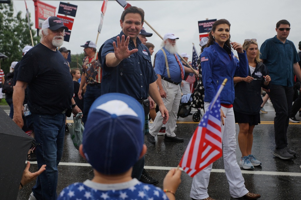 Florida Gov. Ron DeSantis waves to a parade-goer in New Hampshire