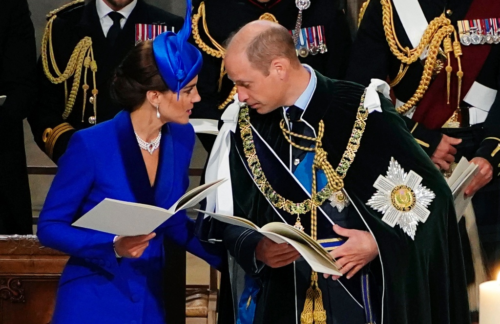 The two were seated next to each other, while Prince William wore official outfitting. 