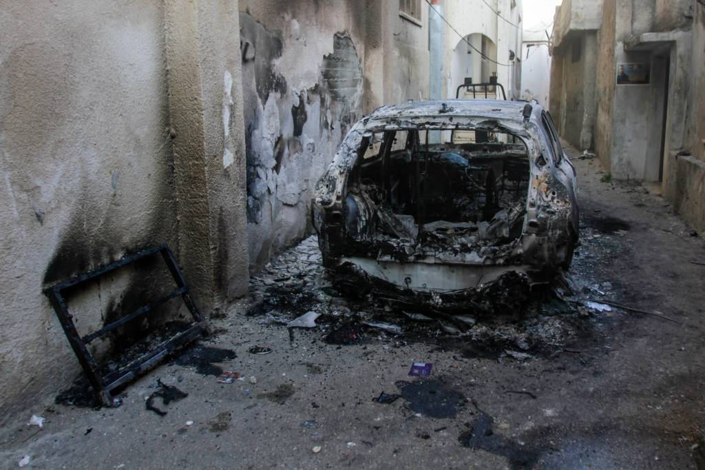 Palestinians clean up debris in the aftermath of an Israeli military operation in Jenin.