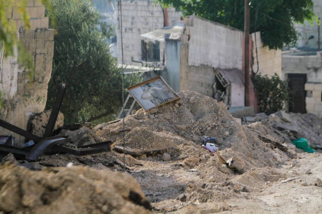 Palestinians clean up debris in the aftermath of an Israeli military operation in Jenin.