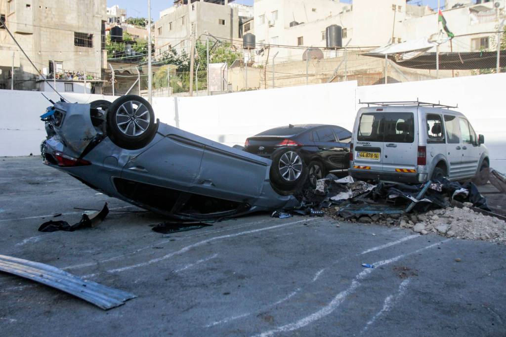 Palestinians clean up debris in the aftermath of an Israeli military operation in Jenin.