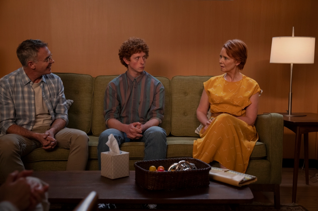 Steve, Brady, and Miranda sit on a couch at family therapy while discussing their home life.