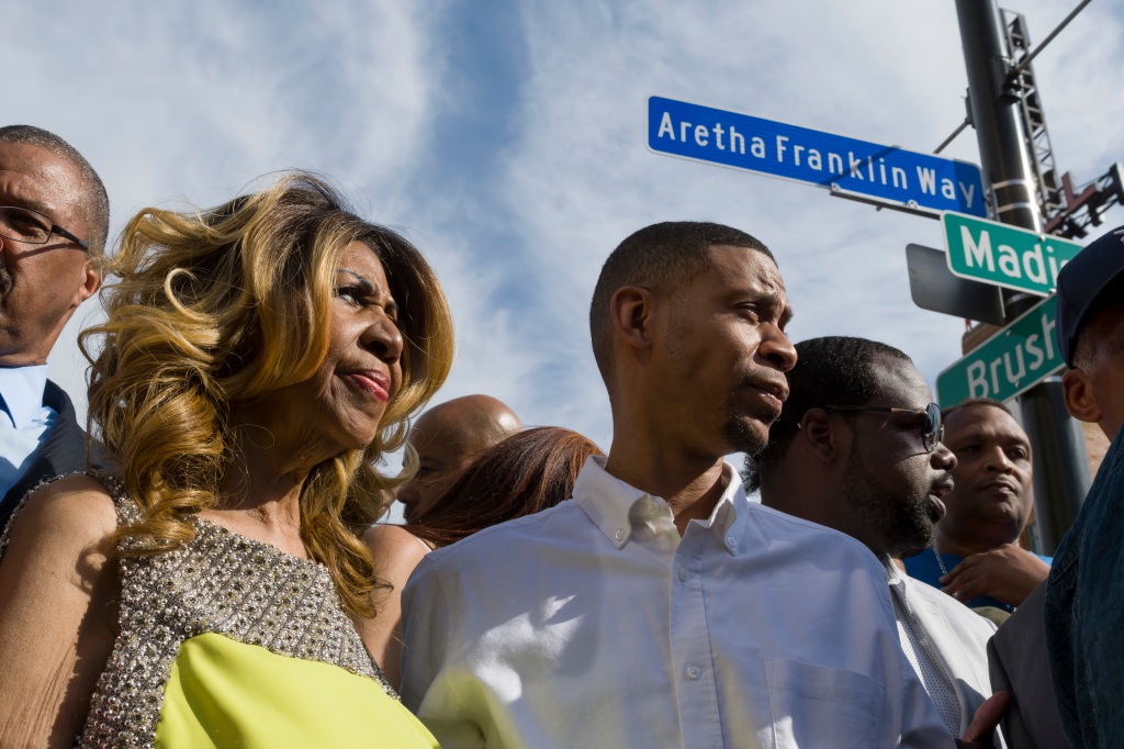 Aretha Franklin and her son Kecalf Cunningham stand under the newly unveiled street sign in front of the Music Hall in Detroit, June 8, 2017.