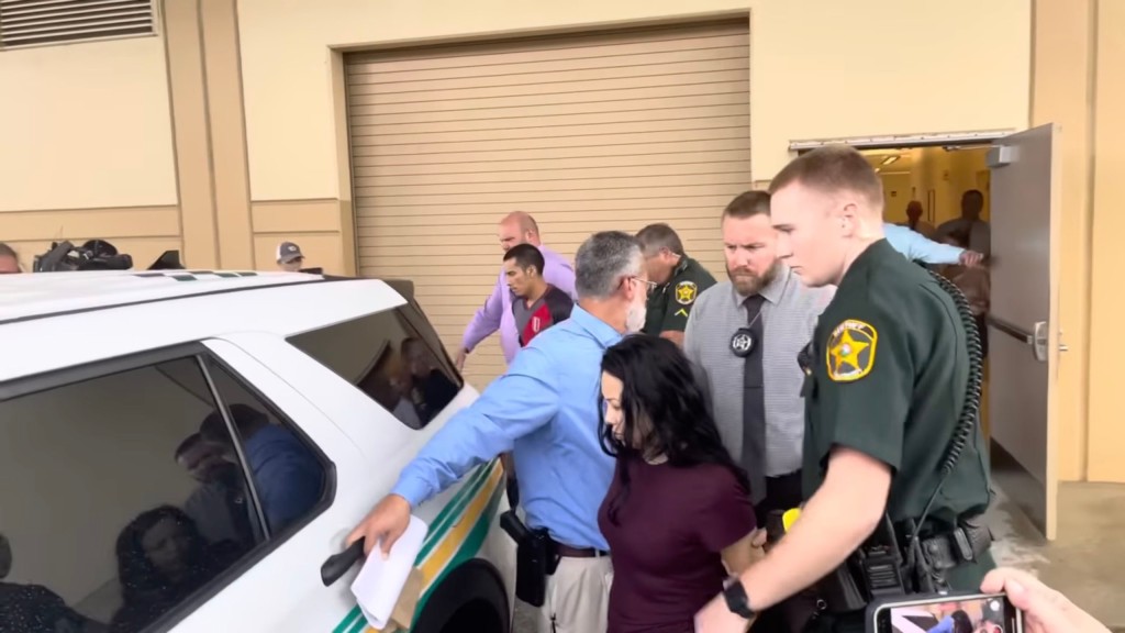 Jazmine Rondon being placed inside a police car