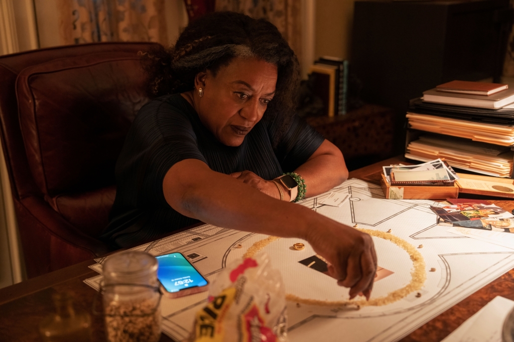 CCH Pounder sitting at a desk looking at a diagram. 