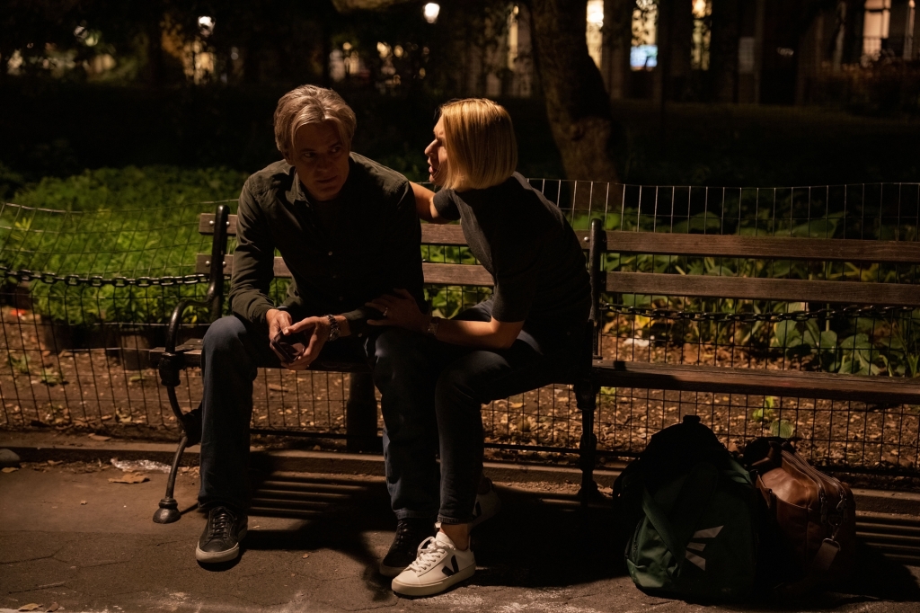 Timothy Olyphant and Claire Danes sit on a bench together. 