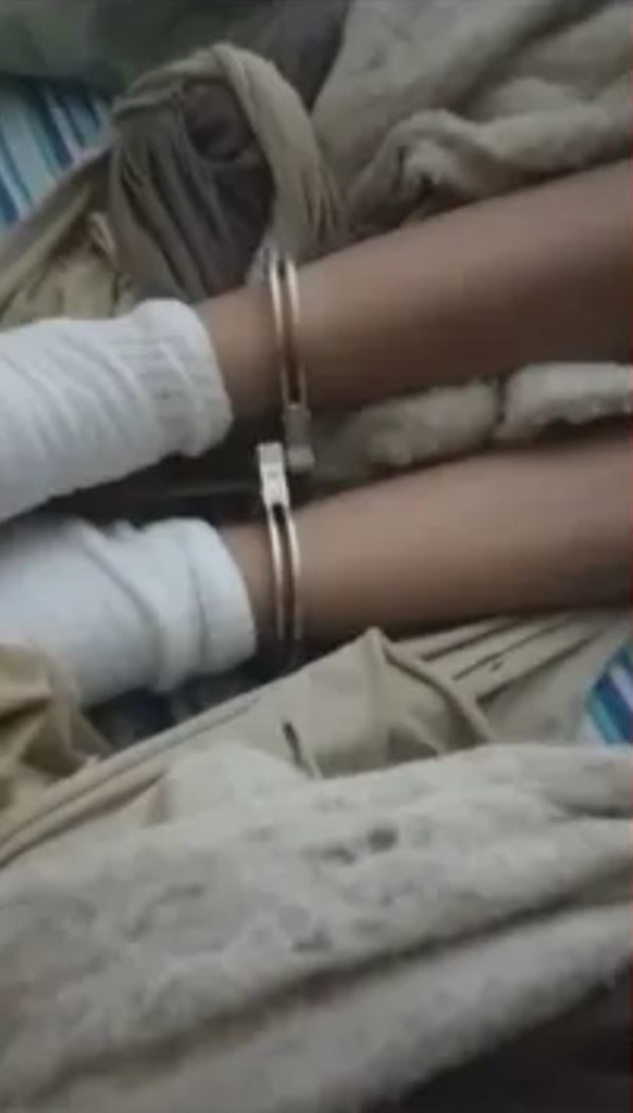 victim's ankles, with handcuffs on them