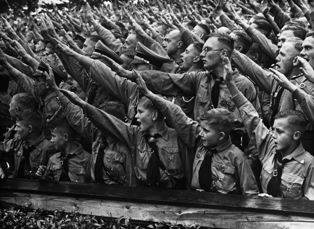 Crowds of Nazi youth saluting their support.