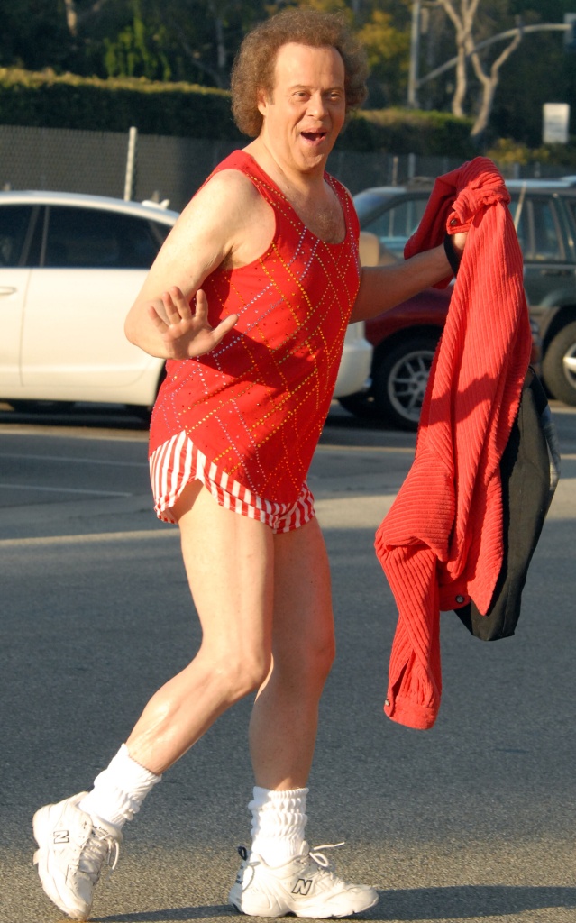 Richard Simmons smiling in a red workout outfit. 