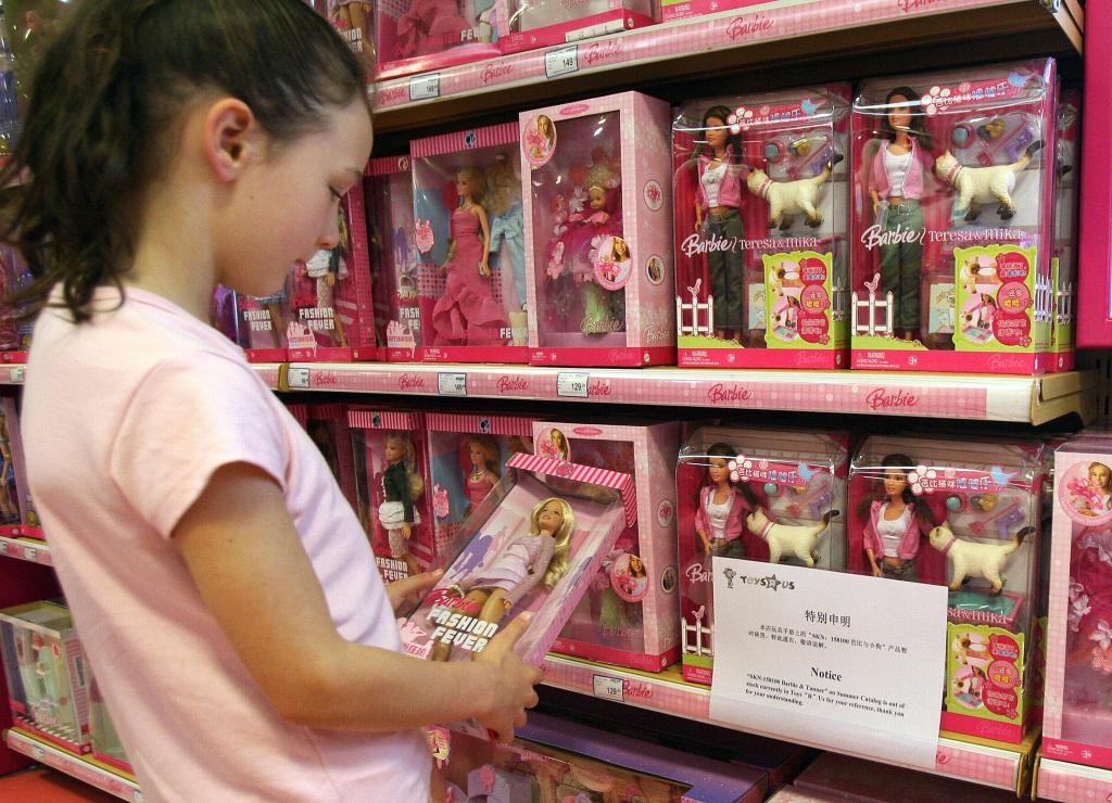 Little girl buying a Barbie