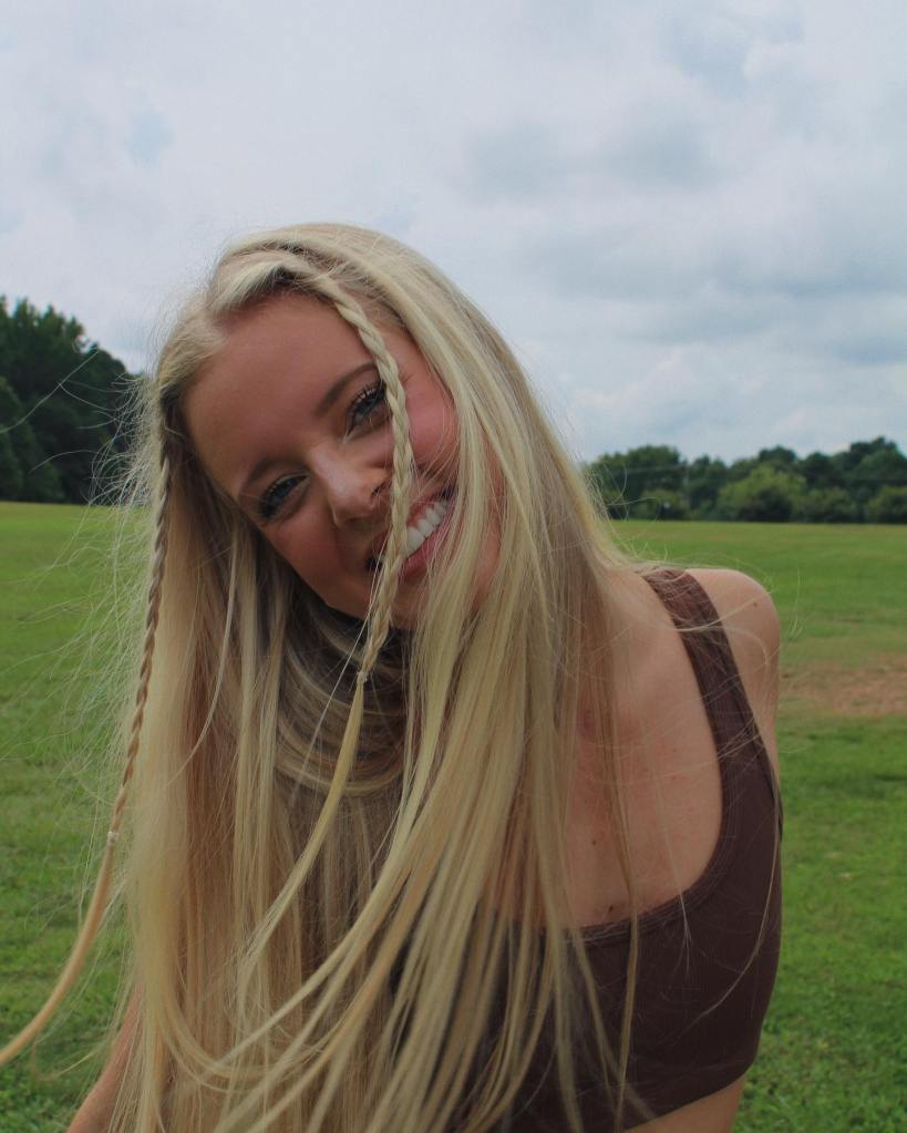 Annabelle Ham in a field smiling for a photo