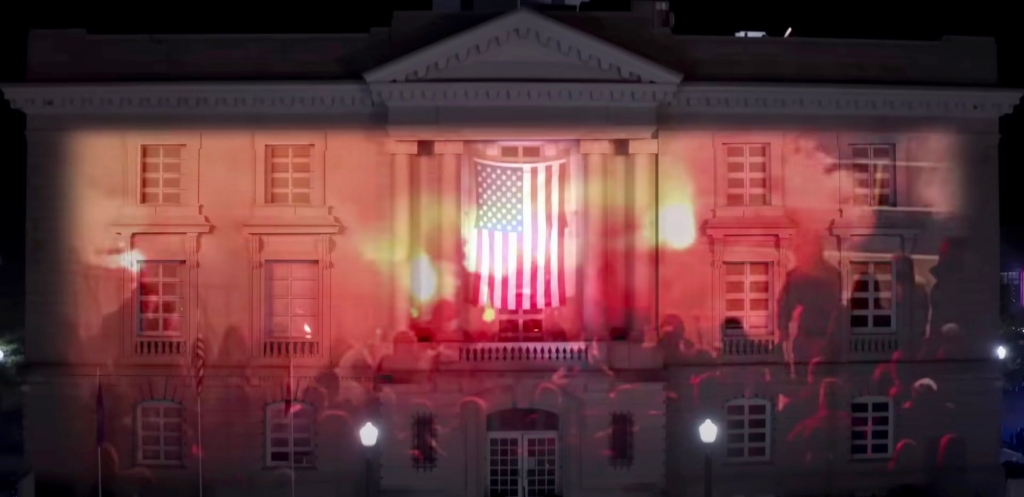 Courthouse in music video with protest footage projected