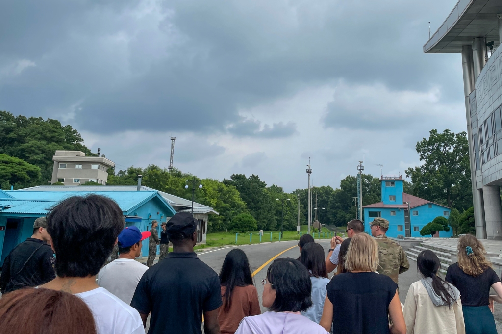 A group of tourists stand near a border station at Panmunjom in the Demilitarized Zone in Paju, South Korea.