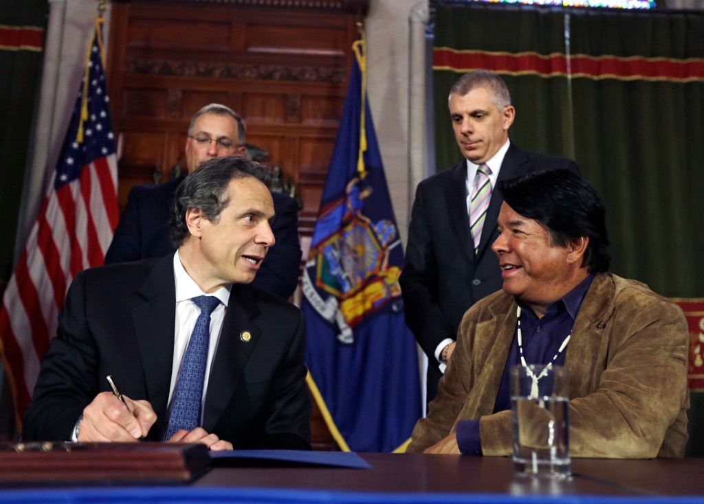 Gov. Andrew Cuomo and Ray Halbritter signing a deal