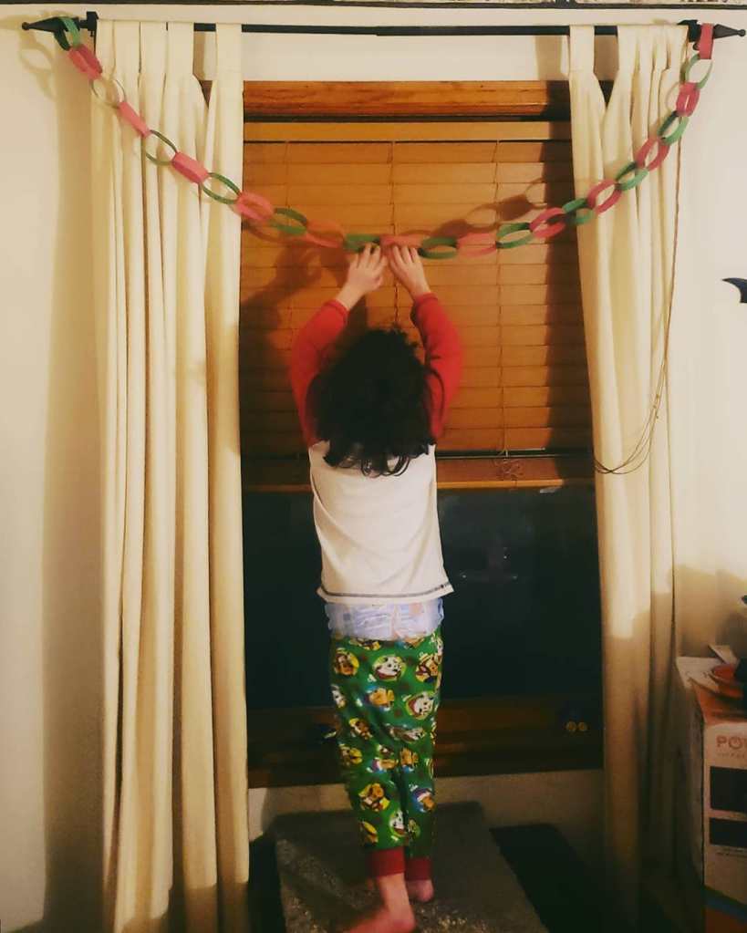 Social media showing one of the boys hanging up a decoration.