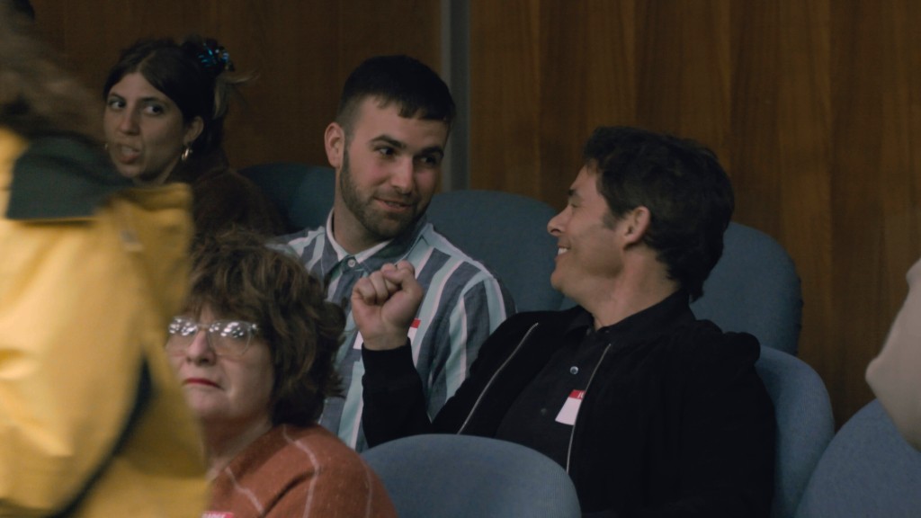 Ronald Gladden and James Marsden  smiling at each other. 