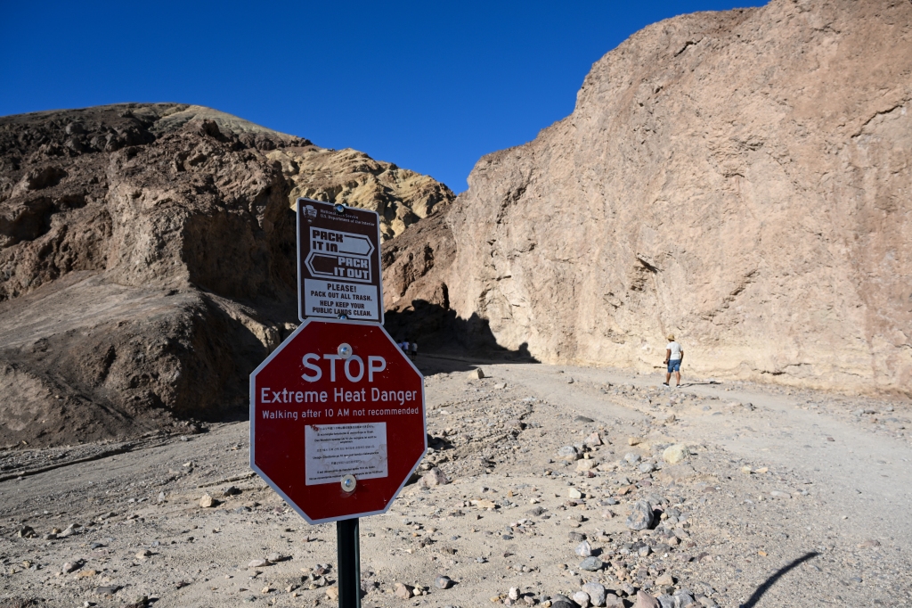 A sign says 'Extreme Heat Danger' at the Golden Canyon Trailhead.