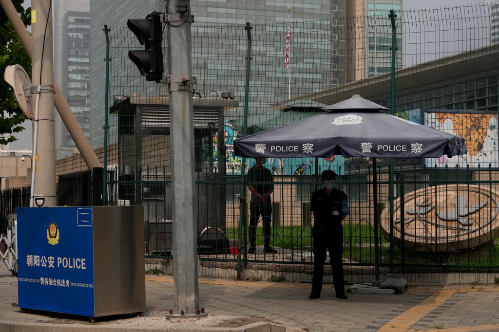 Chinese security personnel guard the U.S. embassy in Beijing.