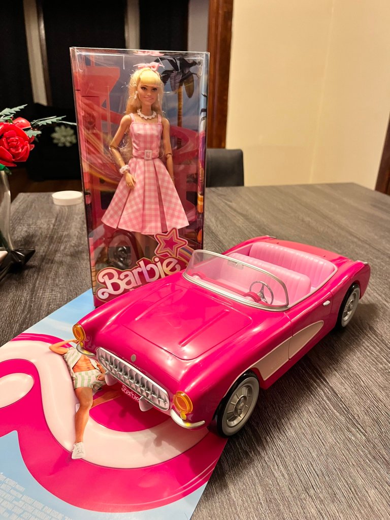 Barbie and car on table