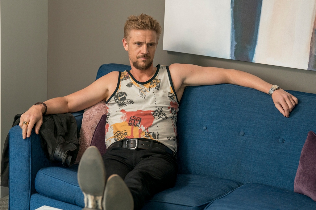 Boyd Holbrook sitting on a couch. 