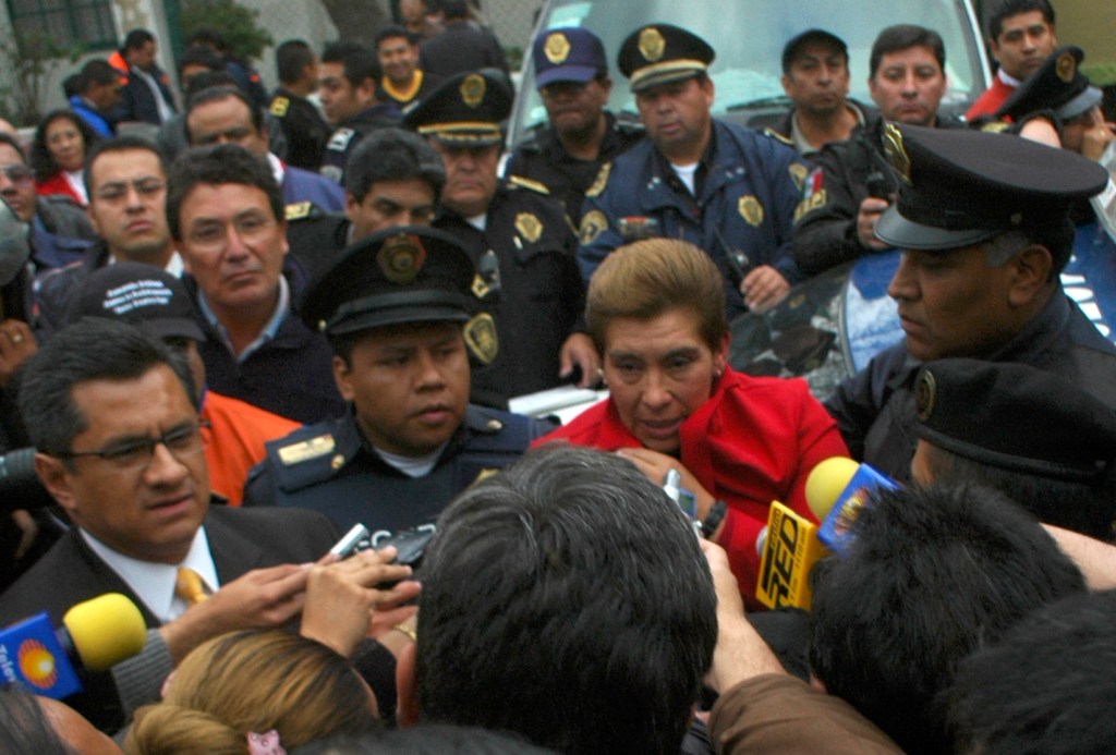 Juana Barraza surrounded by police and media.