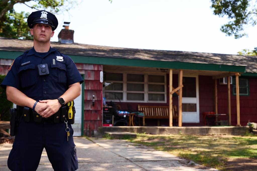 A police officer outside of the Massapequa Park house during the investigation following Heuermann's arrest.