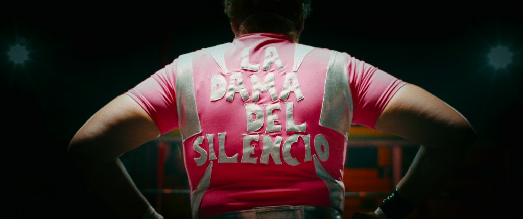 Juana Barraza in her wresting outfit, reading La Dama Del Silencio on the back