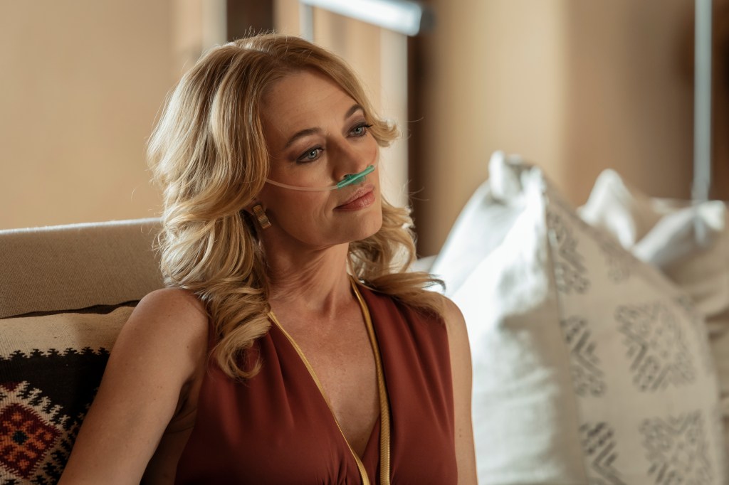 Jeri Ryan with an oxygen apparatus under her nose. 