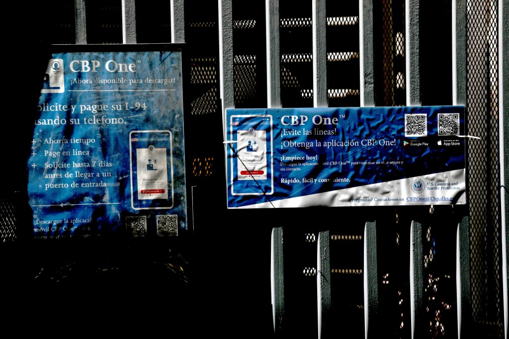 Signs providing information about the CBP One app in Mexicali, Mexico near the US border.