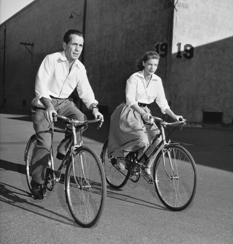 Humphrey Bogart and Lauren Bacall riding bicycles. 