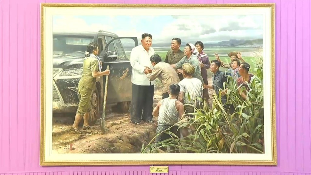 Kim Jong Un glad-handing farmers.