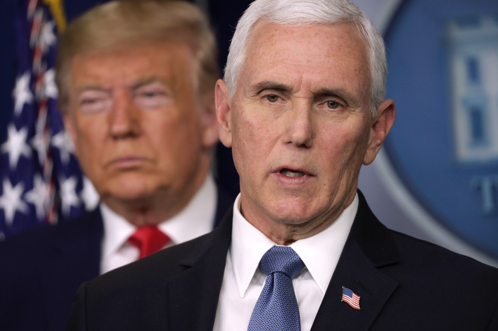 Mike Pence is pictured, with Donald Trump in the background