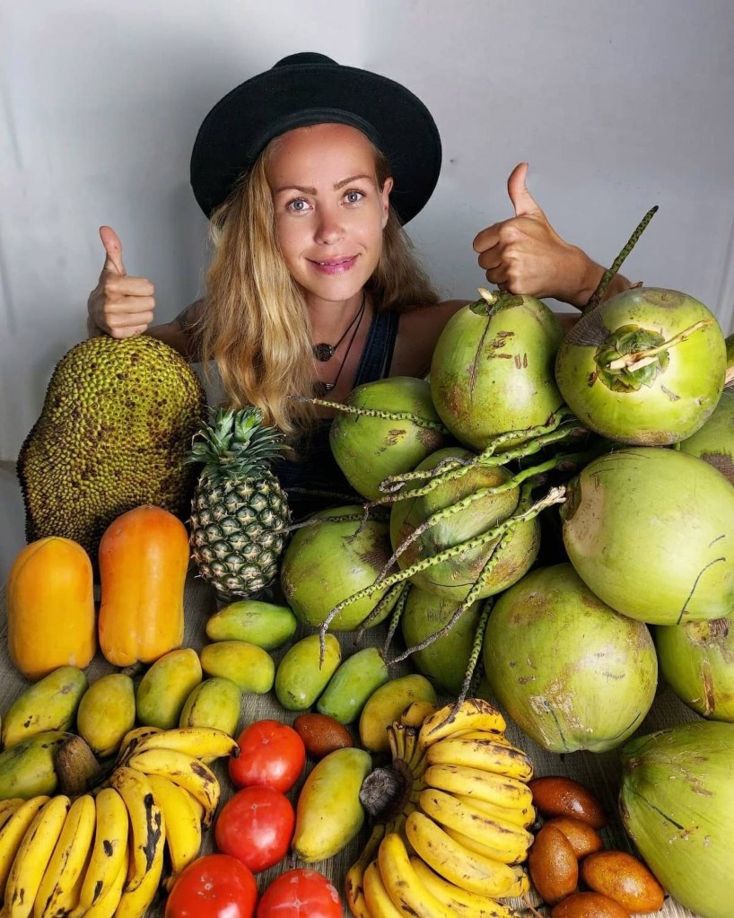 Samsonova with a cornucopia of tropical fruit.