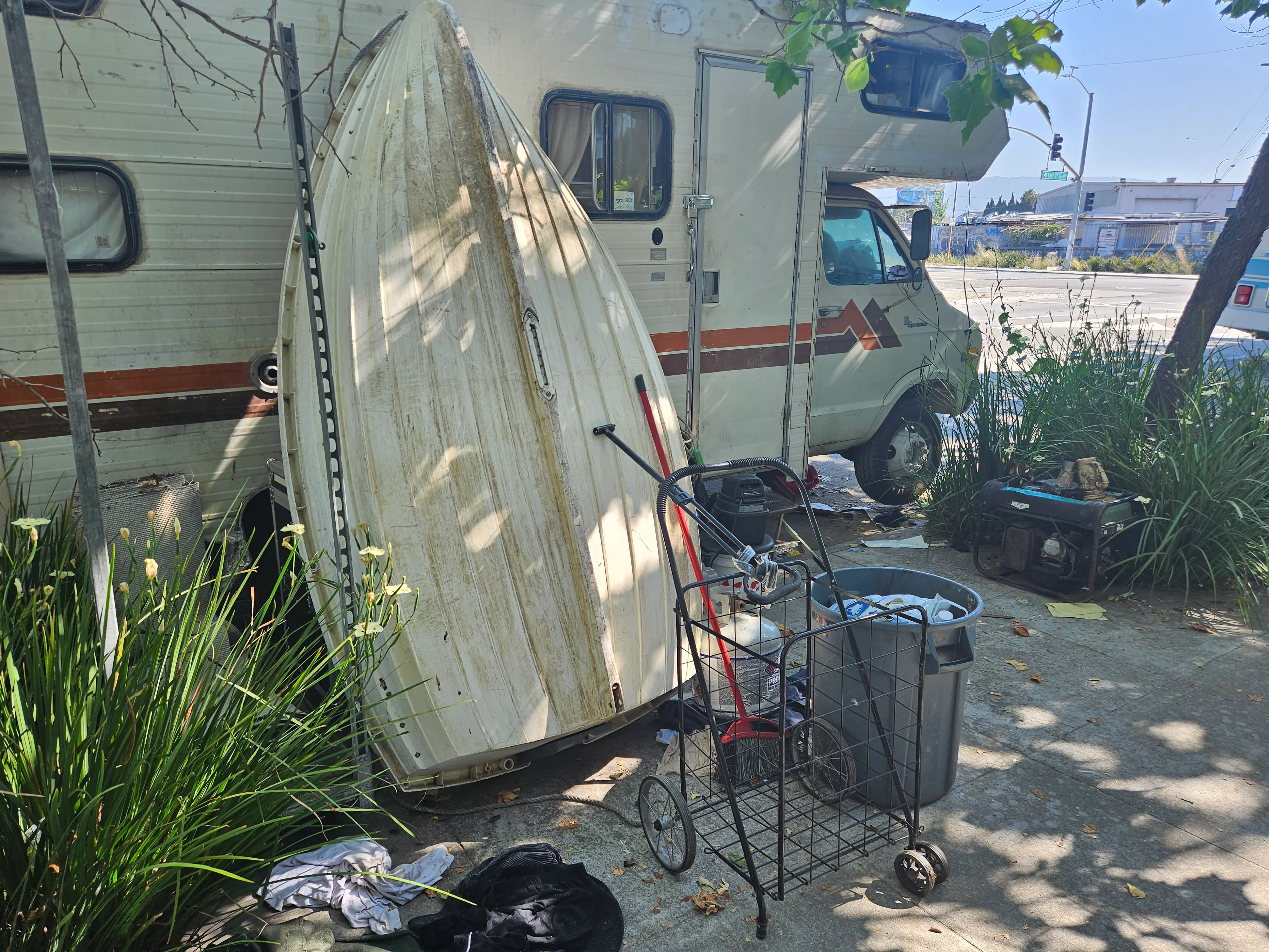 A boat leans on an RV parked outside of the Exchange Studios in Oakland.