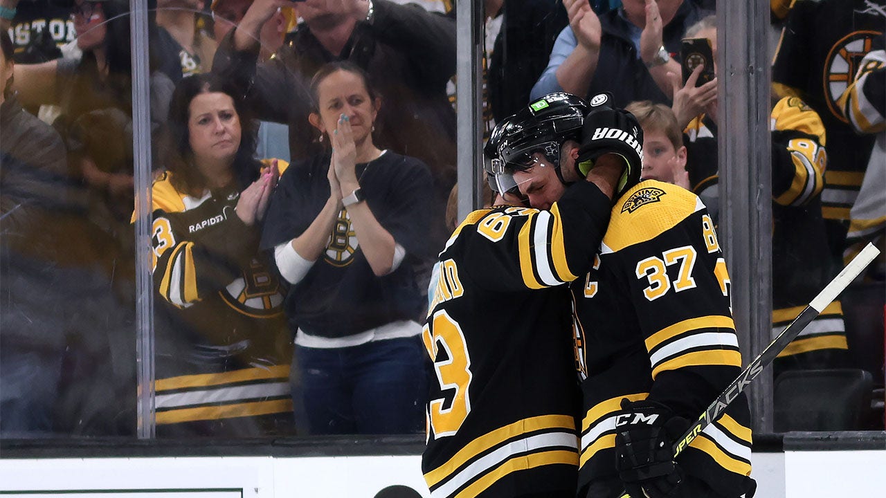 Patrice Bergeron hugs Brad Marchand