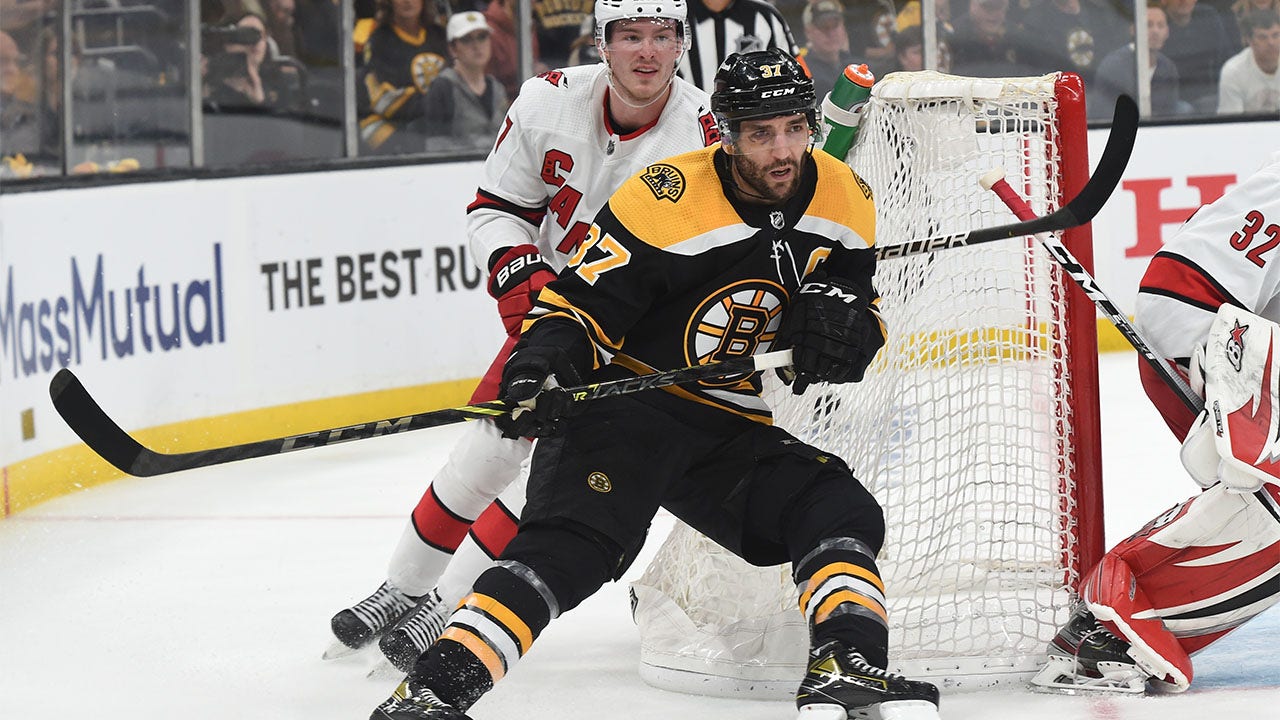 Patrice Bergeron battles with Andrei Svechnikov