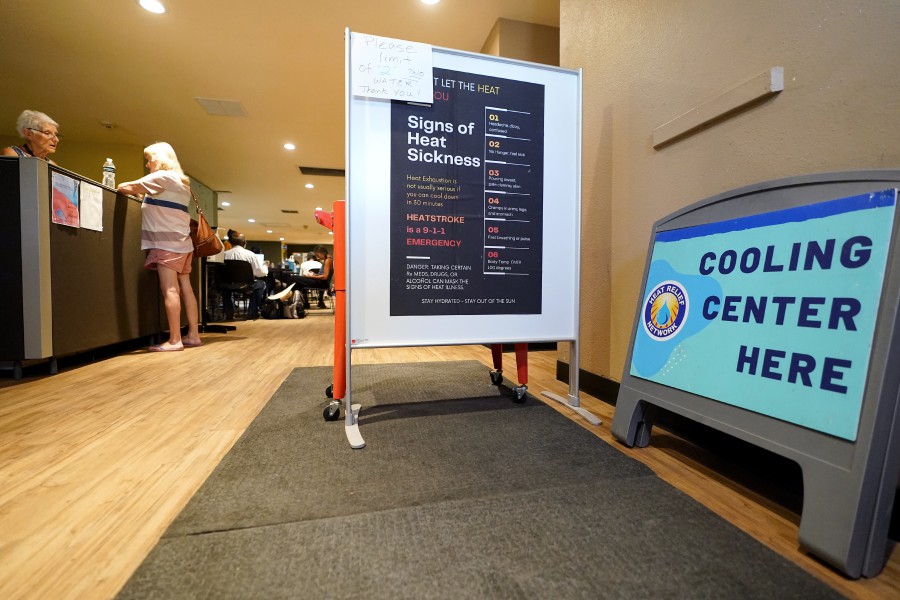 The entrance of the Justa Center, a daytime facility for the homeless, welcomes people into the facility as a cooling center as temperatures are expected to hit 116-degrees Fahrenheit in Phoenix. 