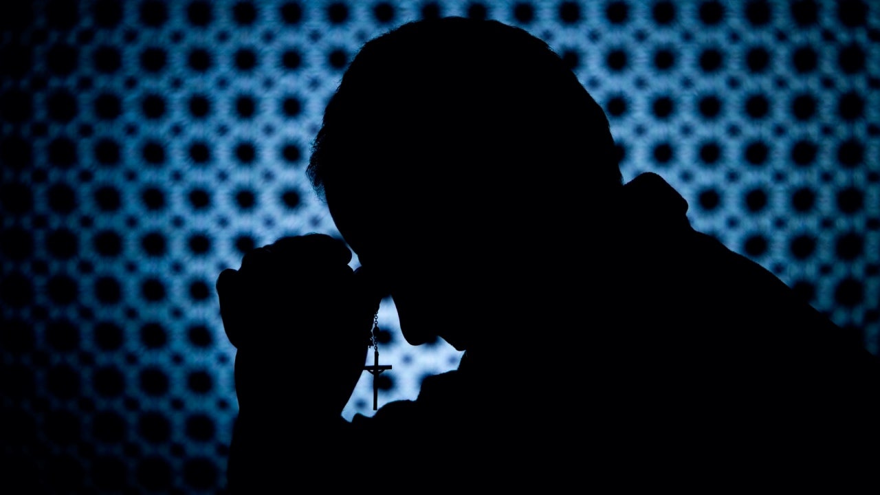 Image of priest in confessional