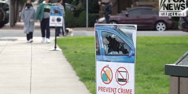 A sign warns residents to take valuables out of their car